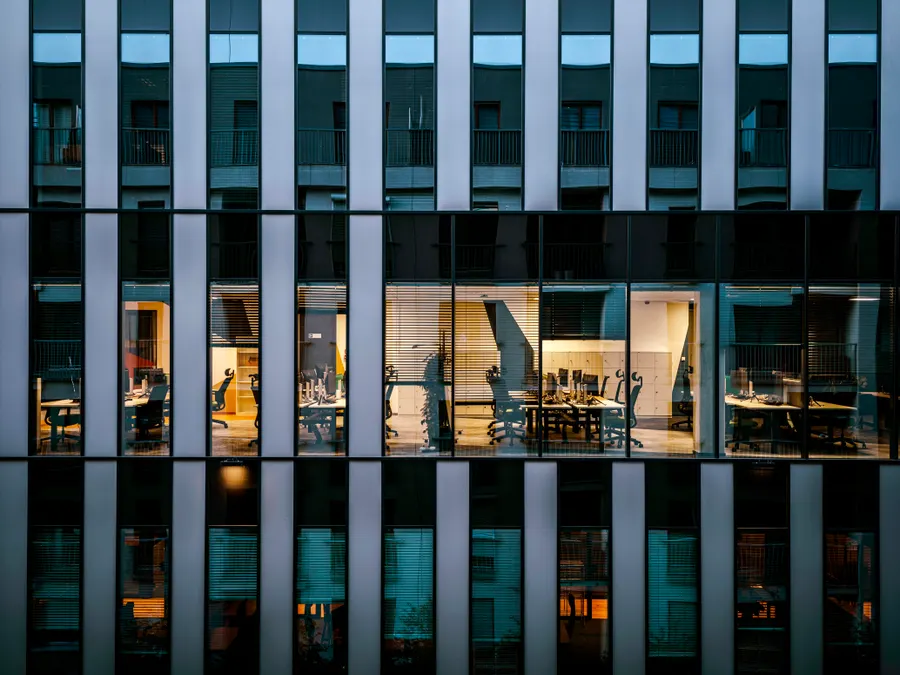 Modern glass office building exterior at dusk