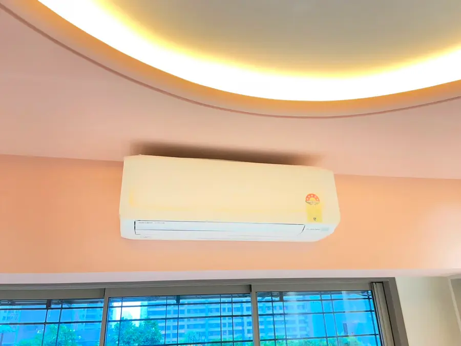 Split AC unit integrated cleanly into a curved, cove-lit false ceiling