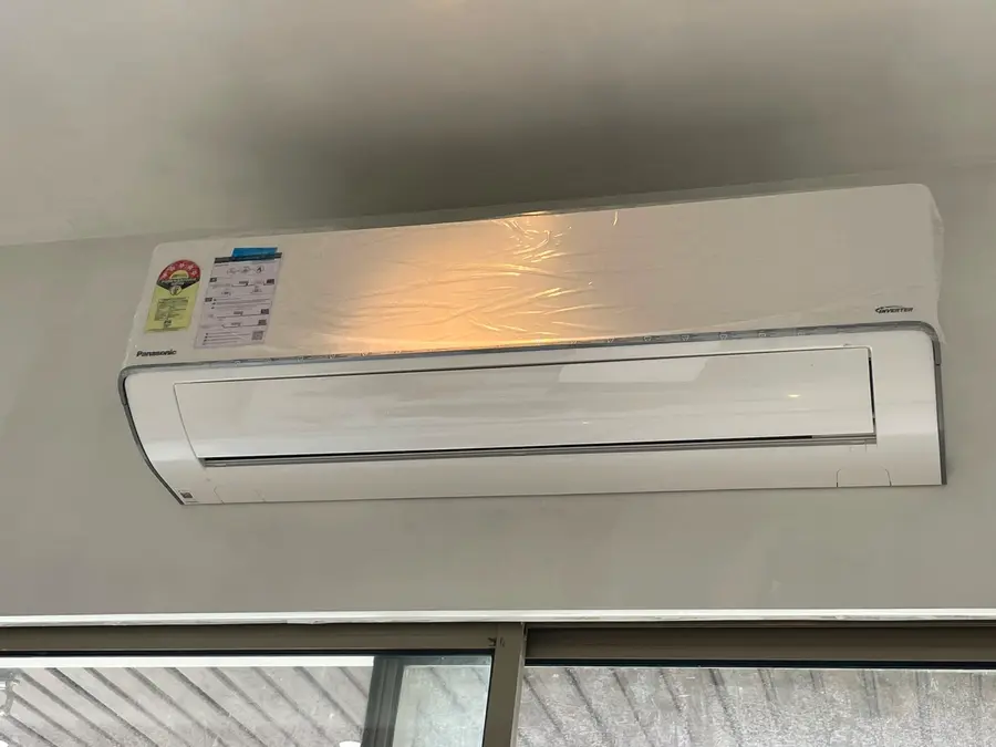 Technician completing a Mithun Shah residential split AC installation