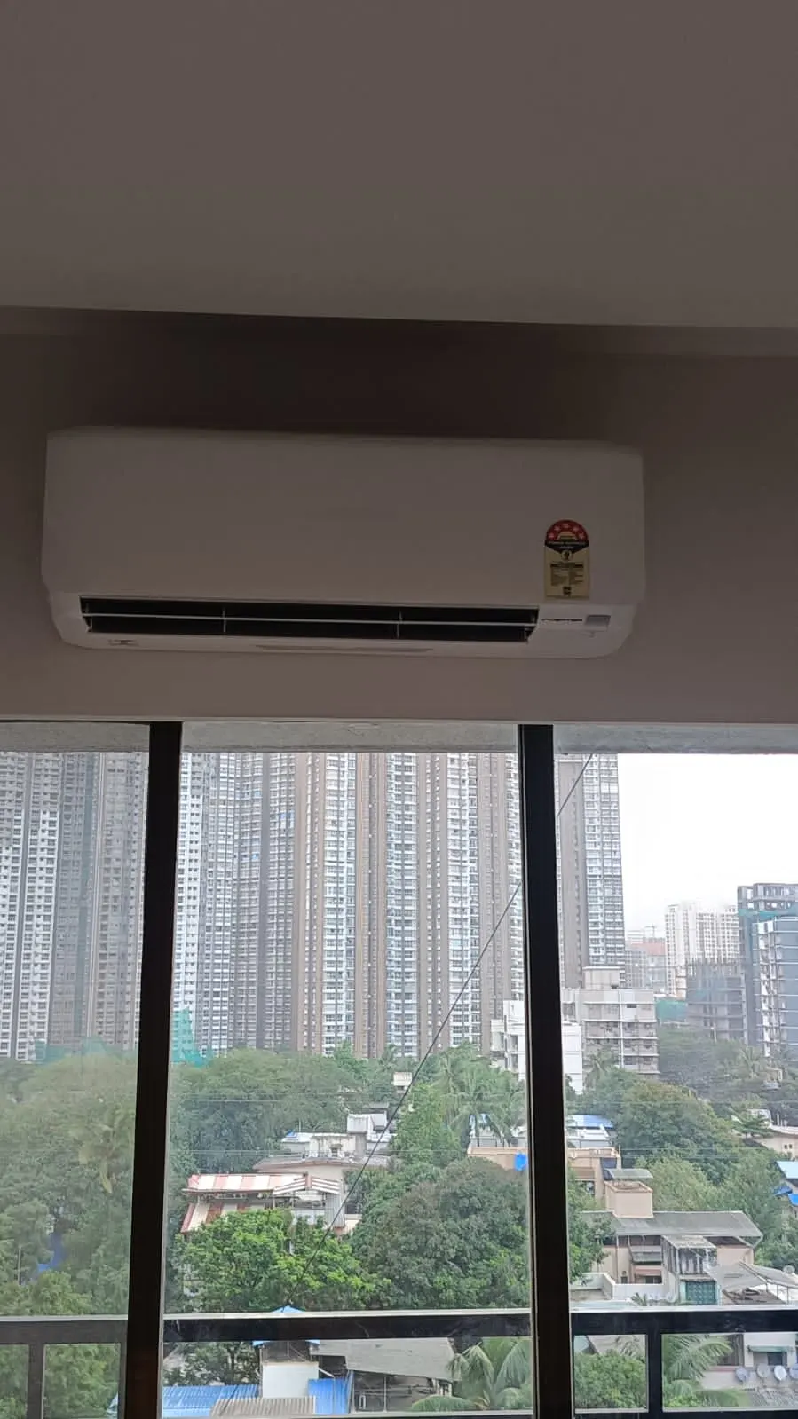 Split AC indoor unit installed with a Mumbai skyline view